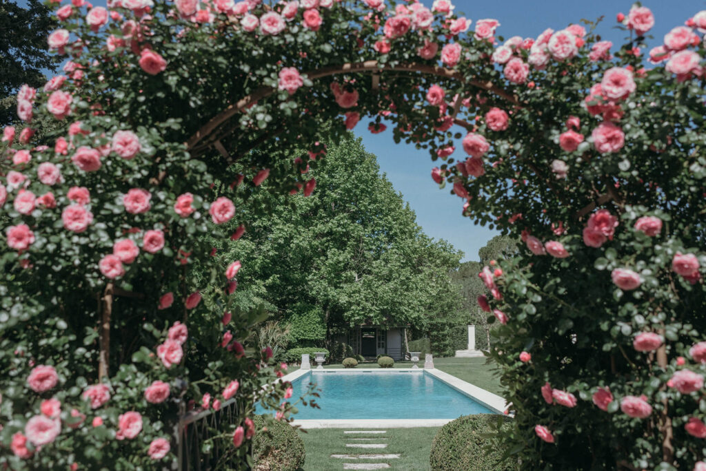 Pink rose archway to the swimming pool at Chateau d'Estoublon