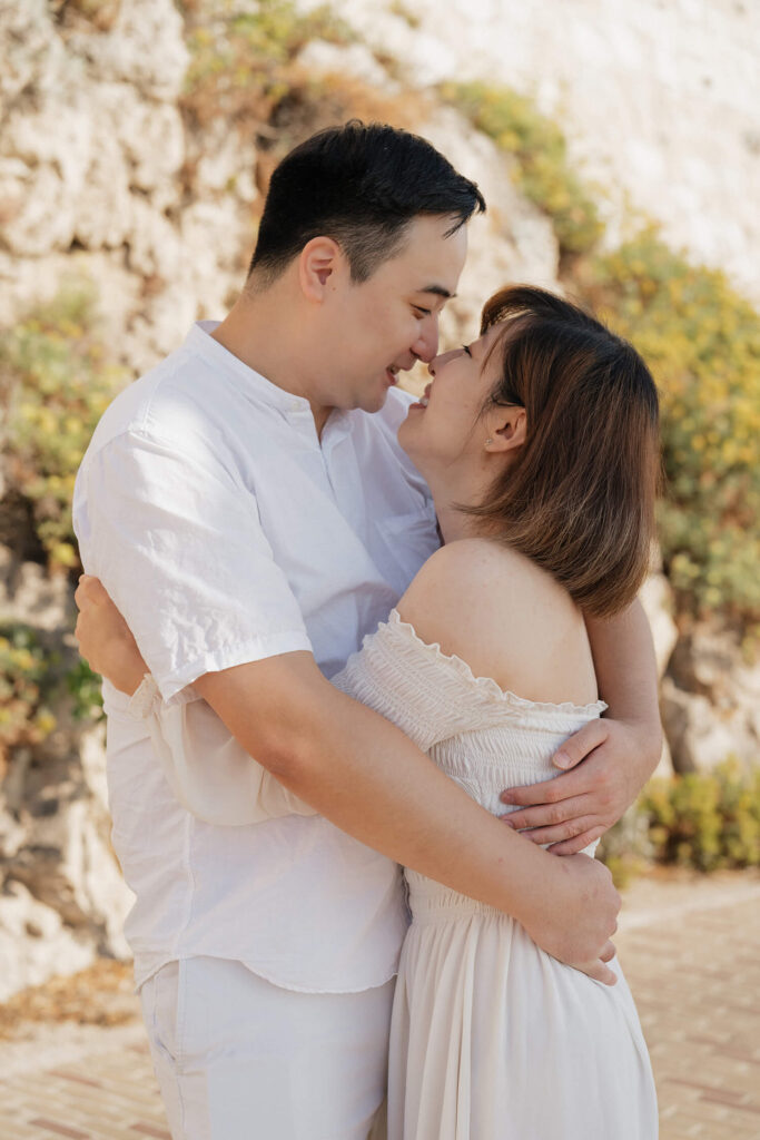 Close-up honeymoon portrait of a couple touching noses in Antibes, French Riviera
